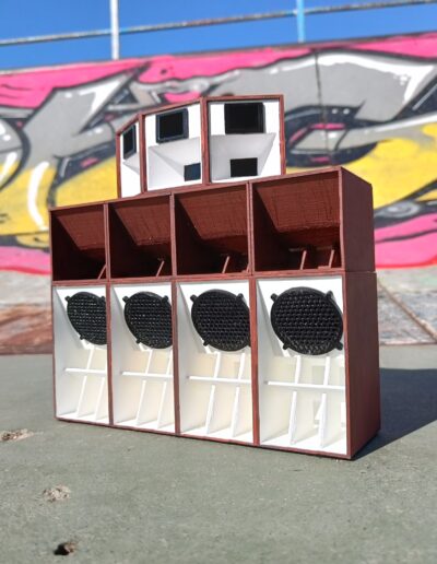 Red Oak Sound System Mini Replica with Bluetooth and rechargeable battery, against an urban graffiti backdrop.