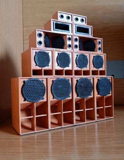 Complete setup of a miniature reggae sound system kit on a wooden surface.