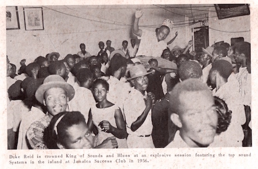 Duke Reid is crowned King of Sounds and Blues at an explosive session featuring the top sound systems on the island at Jamaica Success Club in 1956. Photo capturing the lively atmosphere and celebration