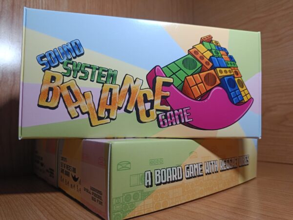 Close-up of the Sound System Balance Game packaging with the game title and reggae-themed design.